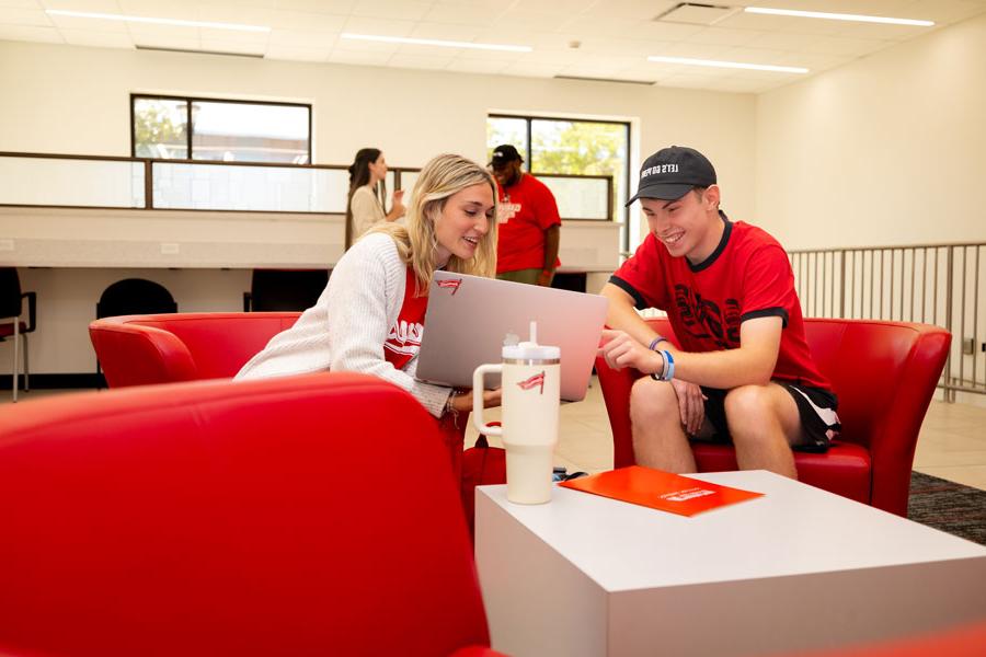 Students talking with their laptops